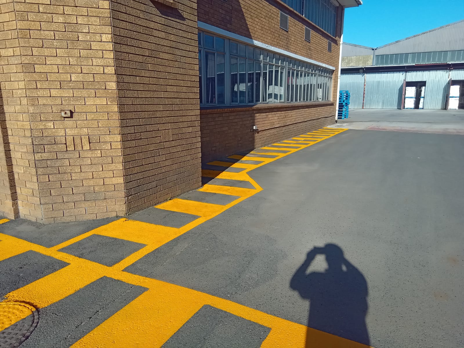 Yellow safety walkway against face brick